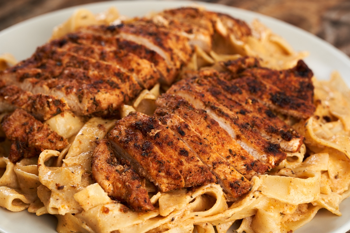 Chicken Marsala served over fettuccine pasta with a creamy mushroom sauce.