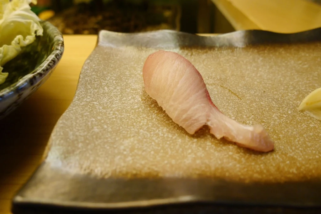 Single Piece of Hamachi Nigiri on a Plate