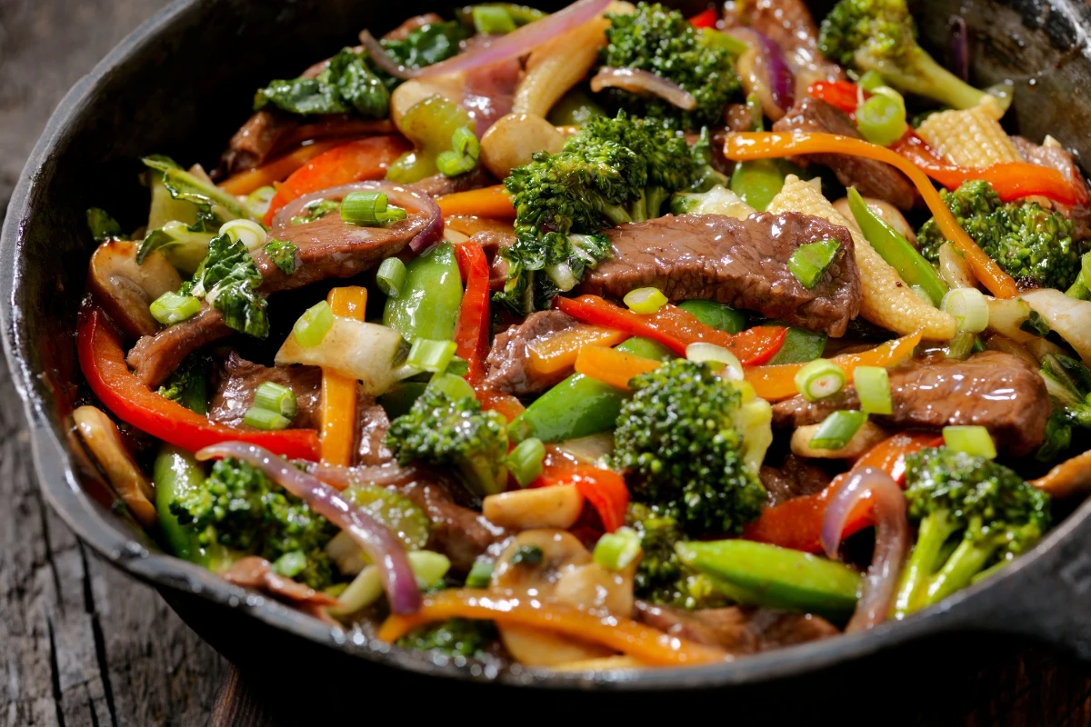 A colorful veggie beef stir fry with broccoli, bell peppers, snap peas, and beef slices.